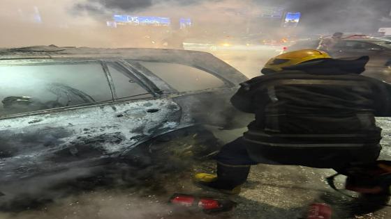 رجال الإنقاذ يخرجون جثة سائق متوفى من سيارة محترقة على طريق السويس الصحراوي